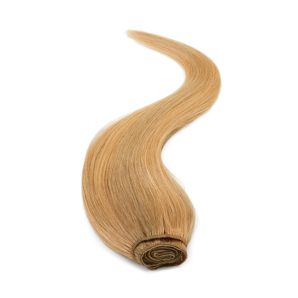 a piece of blonde hair on a white background