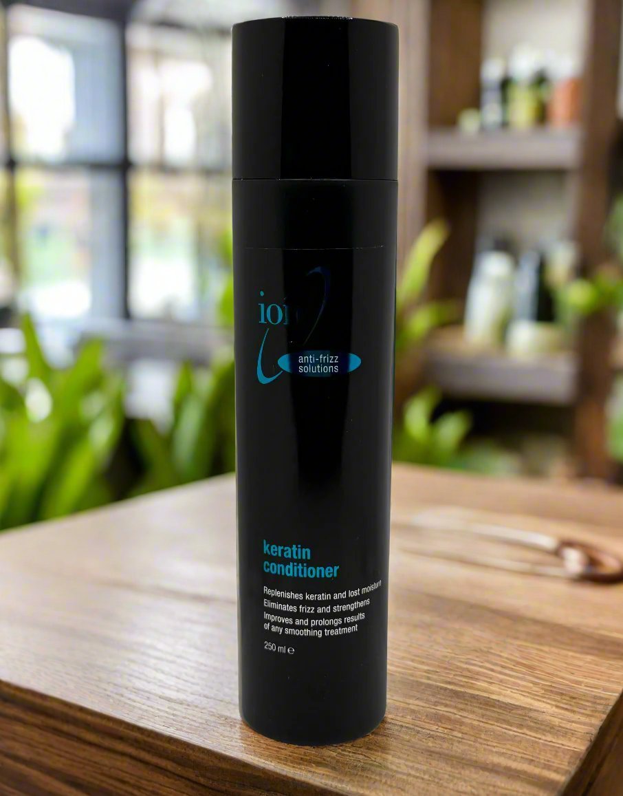 a black bottle sitting on top of a wooden table